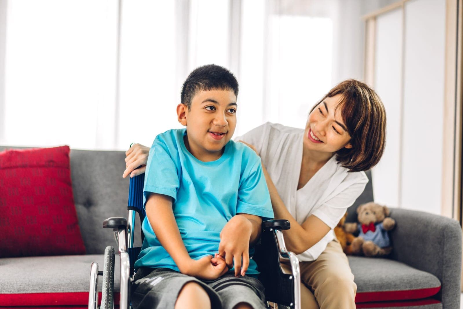 Child in wheelchair with supportive caregiver